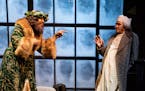 Ansa Akyea as the Ghost of Christmas Present and Nathaniel Fuller as Ebenezer Scrooge in "A Christmas Carol" at the Guthrie Theater.