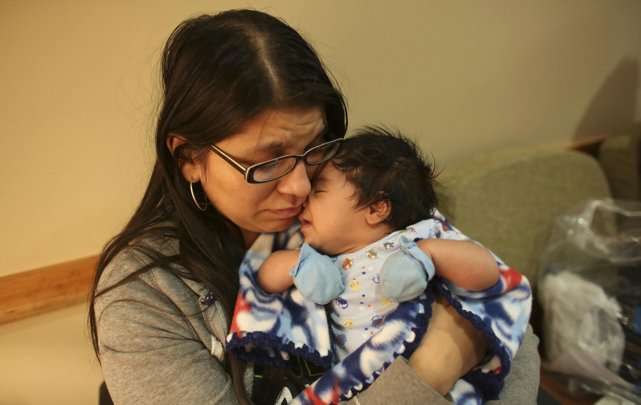 Christina Alonzo held her two-month-old son, Elijah, in the lobby of the Maple Grove Hospital Tuesday evening.