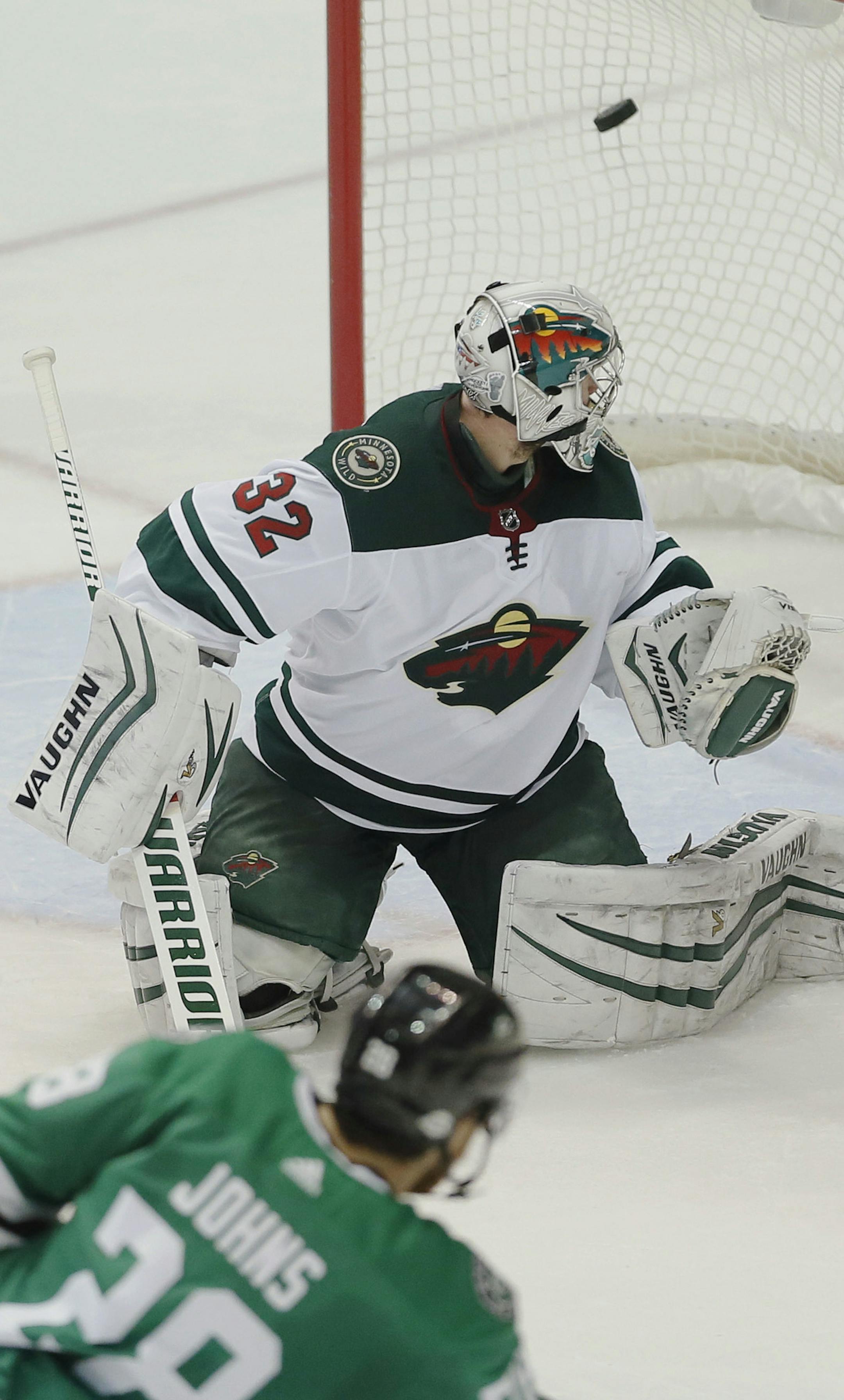 Dallas Stars defenseman Stephen Johns (28) scores a goal on Minnesota Wild goaltender Alex Stalock (32) during the second period of an NHL hockey game Saturday, Feb. 3, 2018, in Dallas. (AP Photo/Brandon Wade)