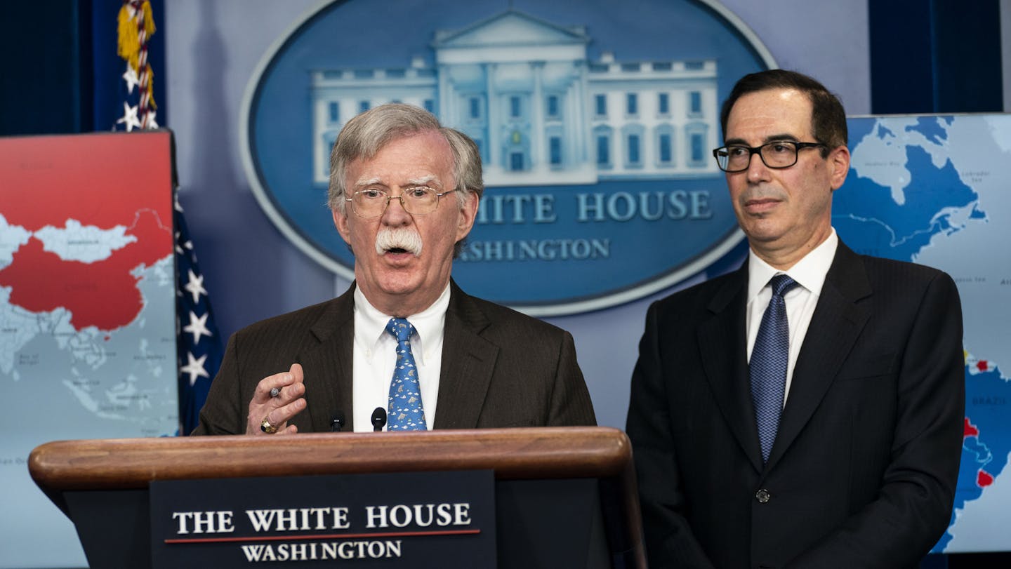 National Security Adviser John Bolton, left, speaks to reporters, as Treasury Secretary Steven Mnuchin looks on, at the White House, in Washington, Jan. 28, 2019. The Trump administration on Monday announced it would impose sanctions on Venezuela&#x2019;s state owned oil monopoly, the most aggressive move to date in President Trump&#x2019;s forceful challenge to Nicol&#xe1;s Maduro, the president of Venezuela. &#x201c;The president has made it very clear on this matter that all options are on th