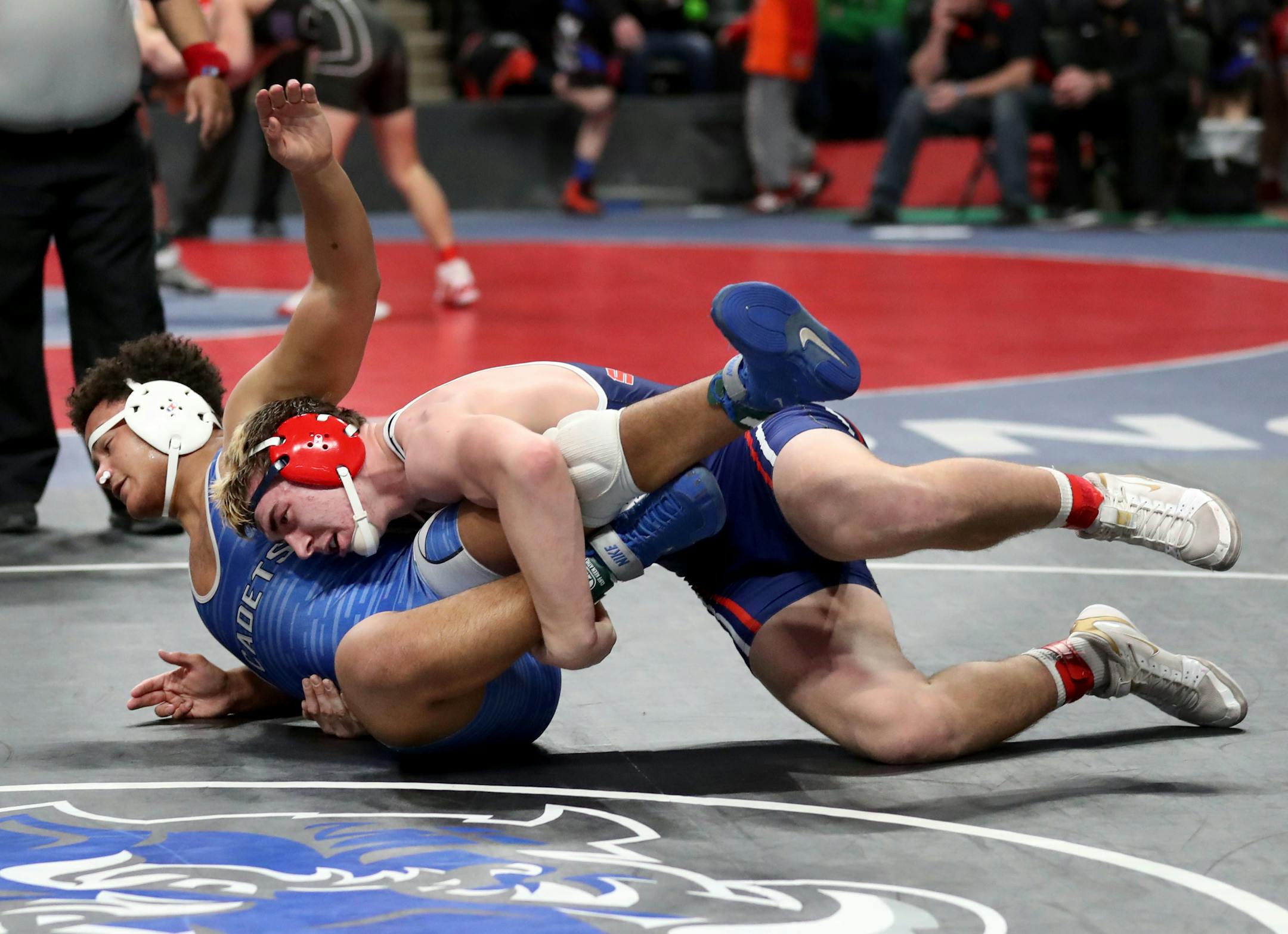 Danny Striggow of Orono, top, threw down Garrison Solliday of St. Thomas Academy