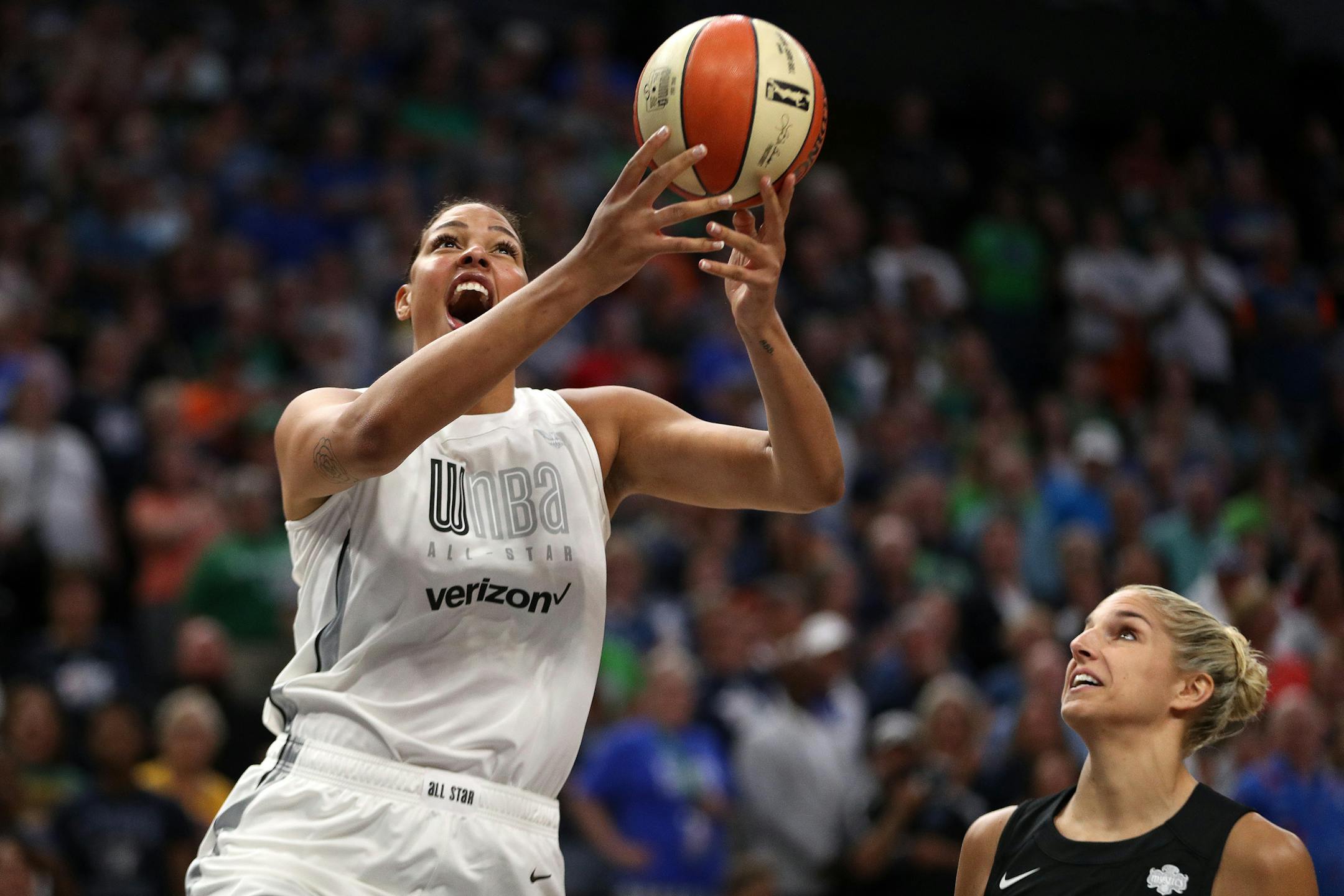 Team Parker center Liz Cambage (8) drove to the basket past Team Delle Donne forward Elena Delle Donne (11) in the first half.