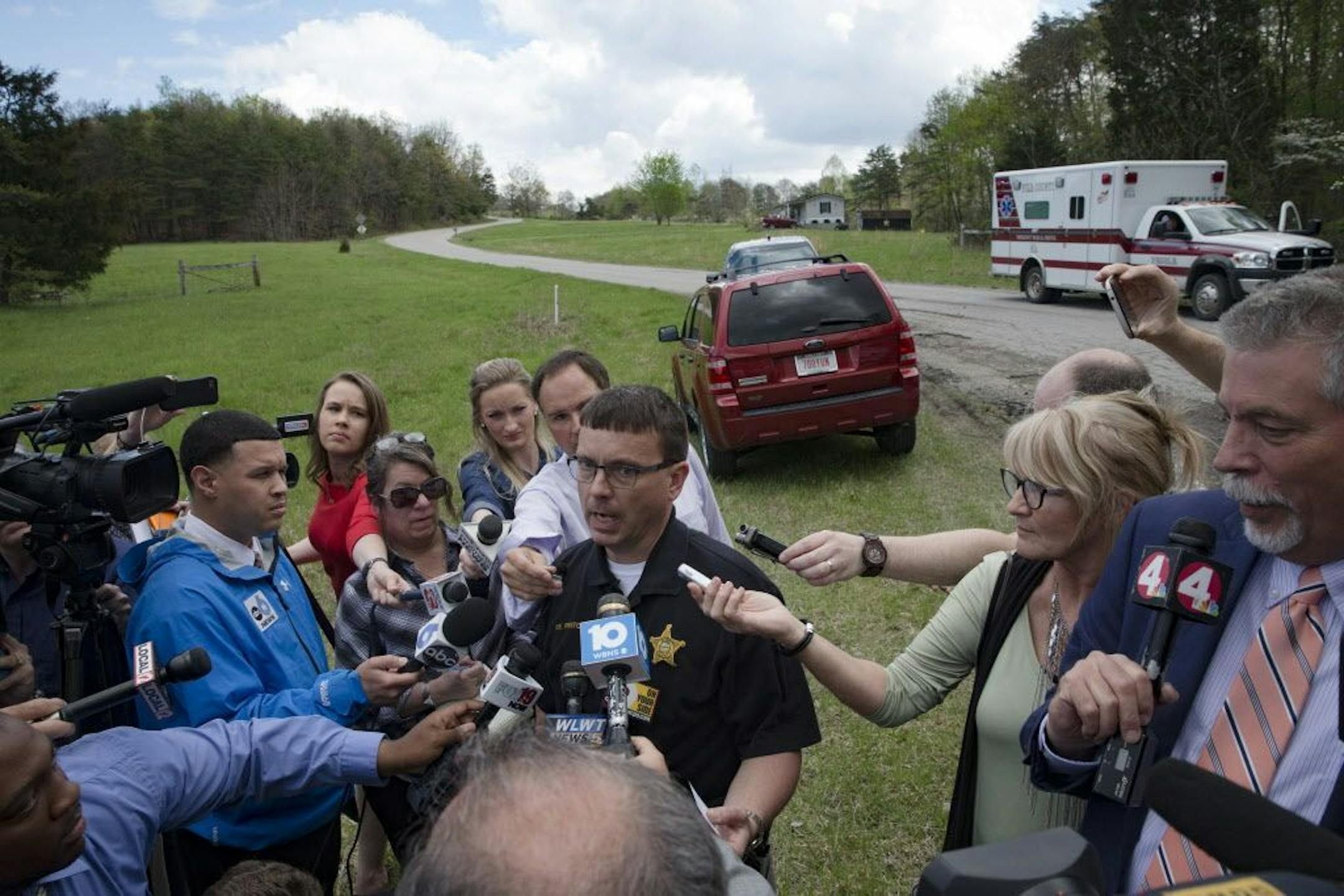 Lt. Michael Preston, of the Ross County Sheriff's Department speaks to the media on Union Hill Road that approaches a crime scene, Friday, April 22, 2016, in Pike County, Ohio. Shootings with multiple fatalities were reported along the road in rural Ohio on Friday morning, but details on the number of deaths and the whereabouts of the suspect or suspects weren't immediately clear. The attorney general's office said a dozen Bureau of Criminal Investigation agents had been called to Pike County, a