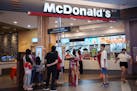 Customers place orders at a McDonald's restaurant in Kuala Lumpur, Malaysia.
