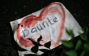 A drawing of Daunte Wright's name lays on the ground as festivities conclude at the Daunte Wright Memorial during a Fourth of July celebration in his