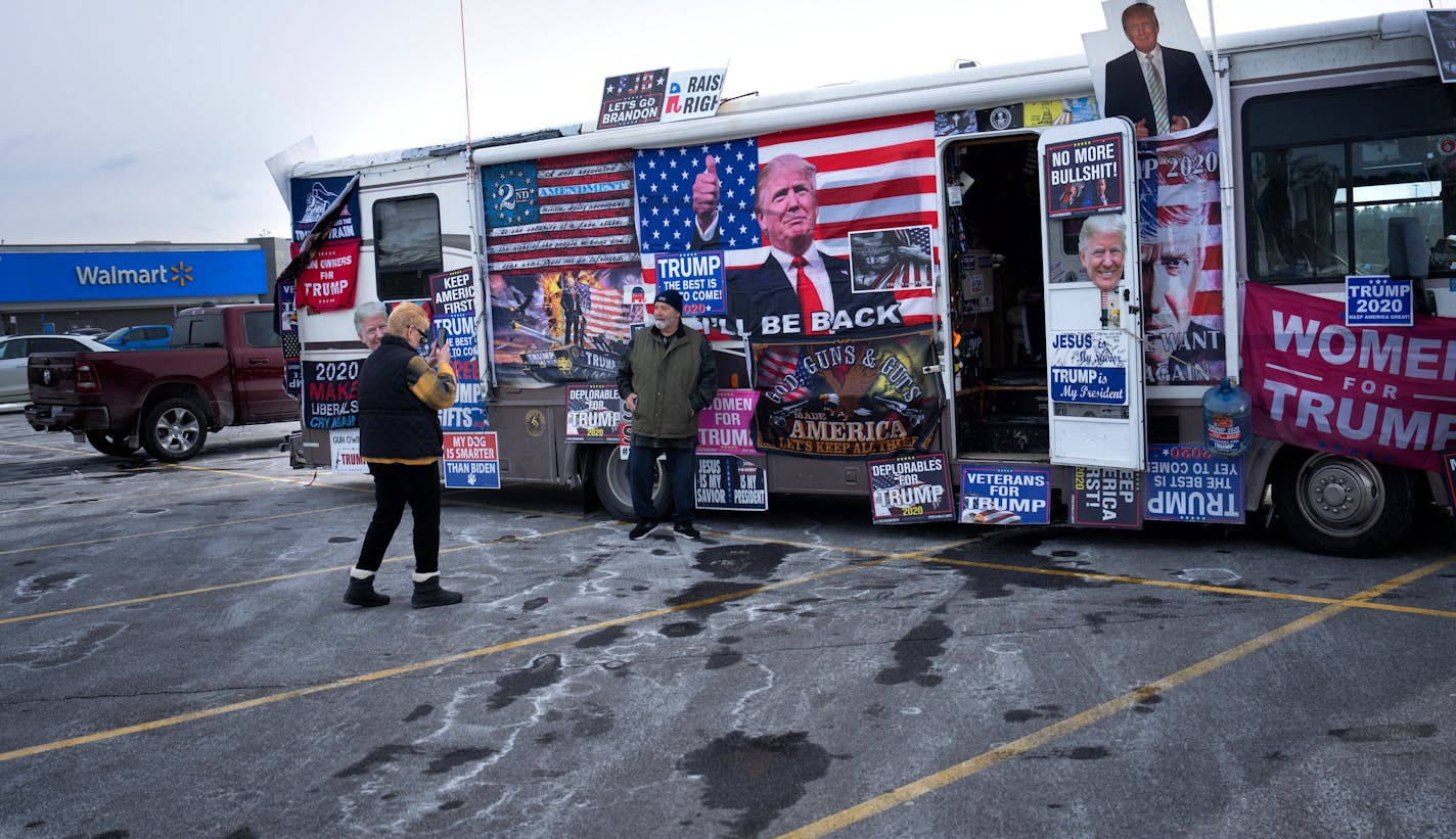 Cyndi Shell took a photo of her husband Scott as he posed with an RV selling Trump merchandise in the Walmart parking lot. Trump supporter Scott said “I have a lot of respect for Dean Phillips, I disagree with a lot of his policies but like how he is sticking it to the DNC.” Friday, Jan. 19, 2024  Concord, New Hampshire.    ] GLEN STUBBE • glen.stubbe@startribune.com