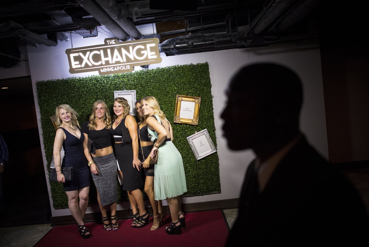 Security guard Jerry Bryant watched over the Exchange Nightclub as a group of patrons had their photo taken.