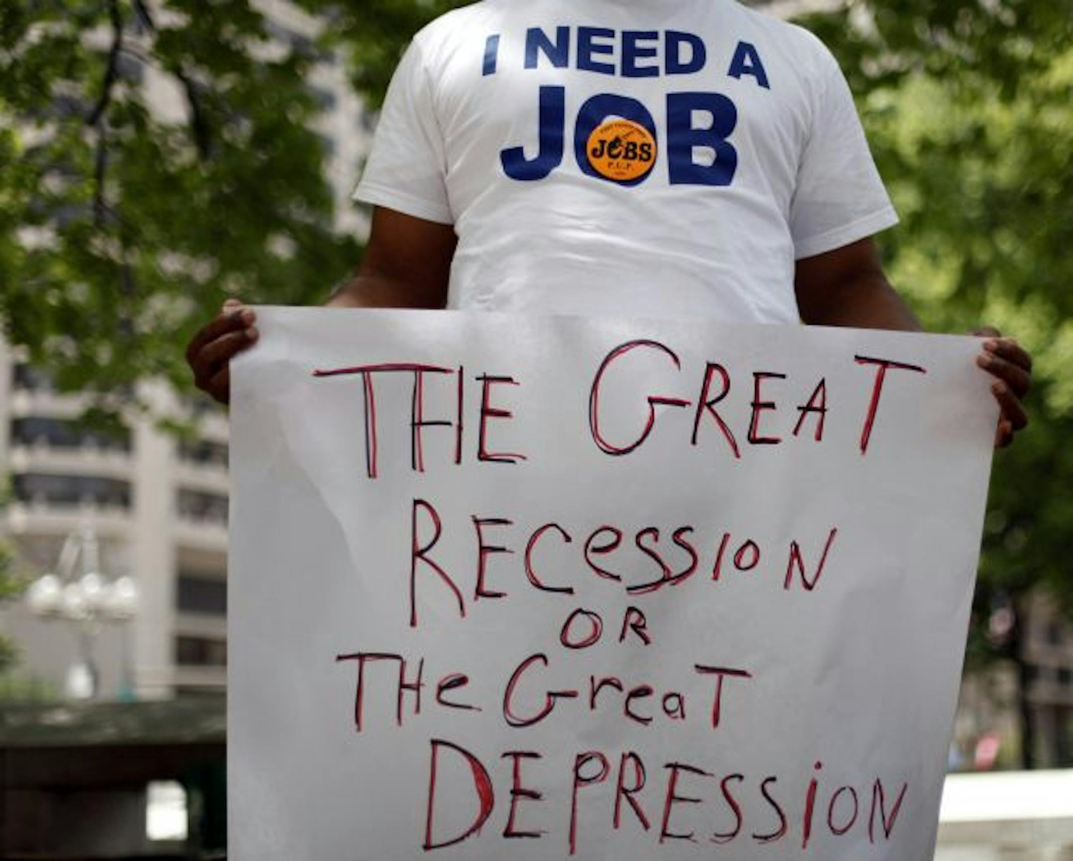 In this Wednesday, June 23, 2010 picture, Frank Wallace, who has been unemployed since May of 2009, holds a sign during a rally organized by the Philadelphia Unemployment Project, in Philadelphia.