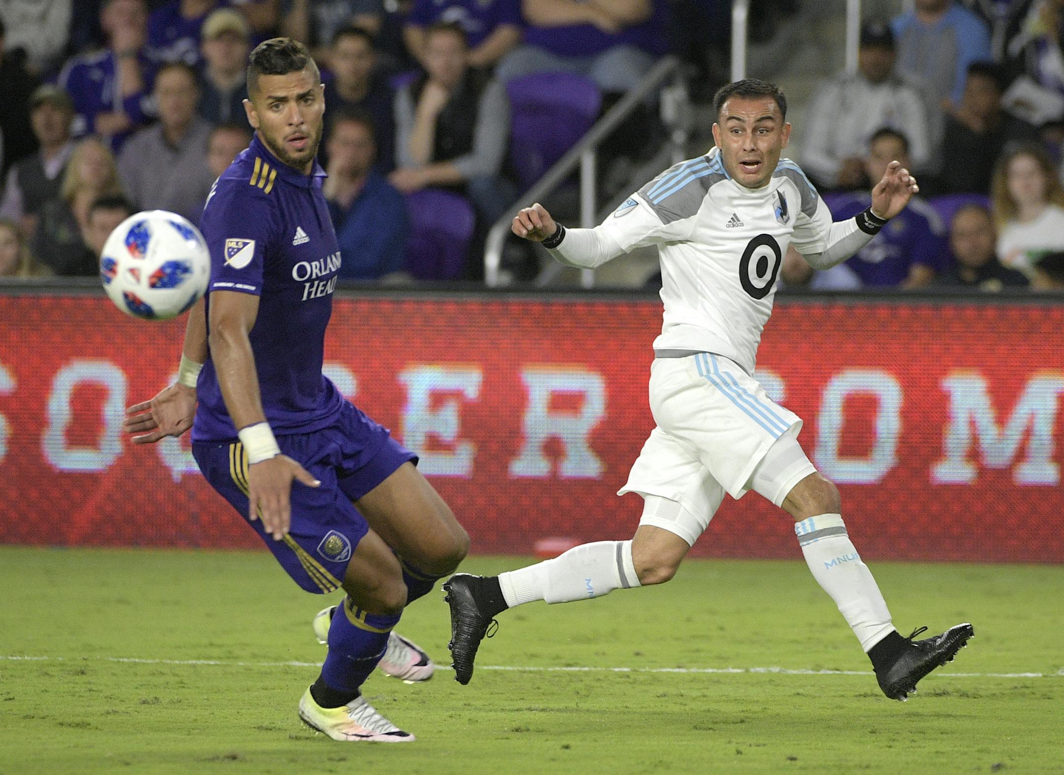 Minnesota United midfielder Miguel Ibarra (10), right, sets up the winning goal past Orlando City defender Amro Tarek (3) during the second half of an MLS soccer match Saturday, March 10, 2018, in Orlando, Fla. Minnesota won 2-1. (Phelan M. Ebenhack for the Star-Tribune) ORG XMIT: OTKMINN112 ORG XMIT: MIN1803102104257401