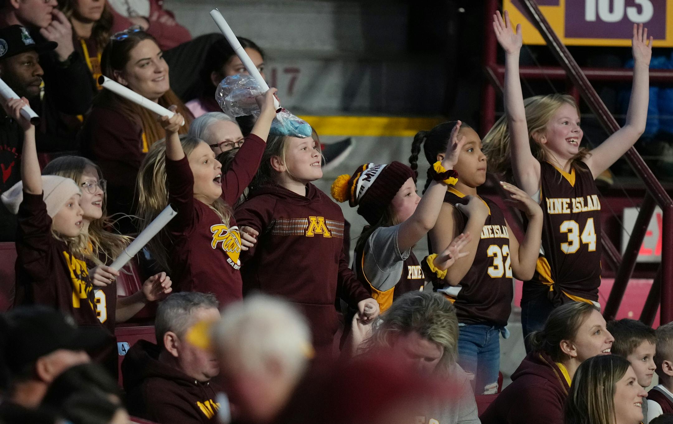 Young Gophers fans cheer for the team in a winning effort against Purdue.