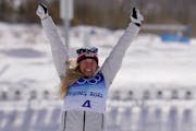 Silver medal finisher Jessie Diggins celebrates during a venue ceremony after the women's 30km mass start free cross-country skiing competition at the