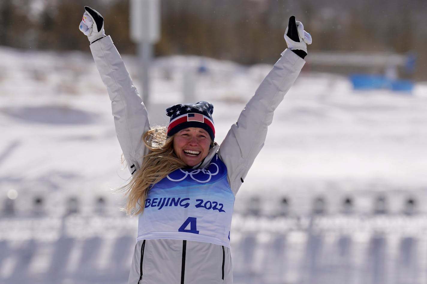 Silver medal finisher Jessie Diggins celebrates during a venue ceremony after the women's 30km mass start free cross-country skiing competition at the 2022 Winter Olympics, Sunday, Feb. 20, 2022, in Zhangjiakou, China. (AP Photo/Alessandra Tarantino)