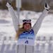 Silver medal finisher Jessie Diggins celebrates during a venue ceremony after the women's 30km mass start free cross-country skiing competition at the