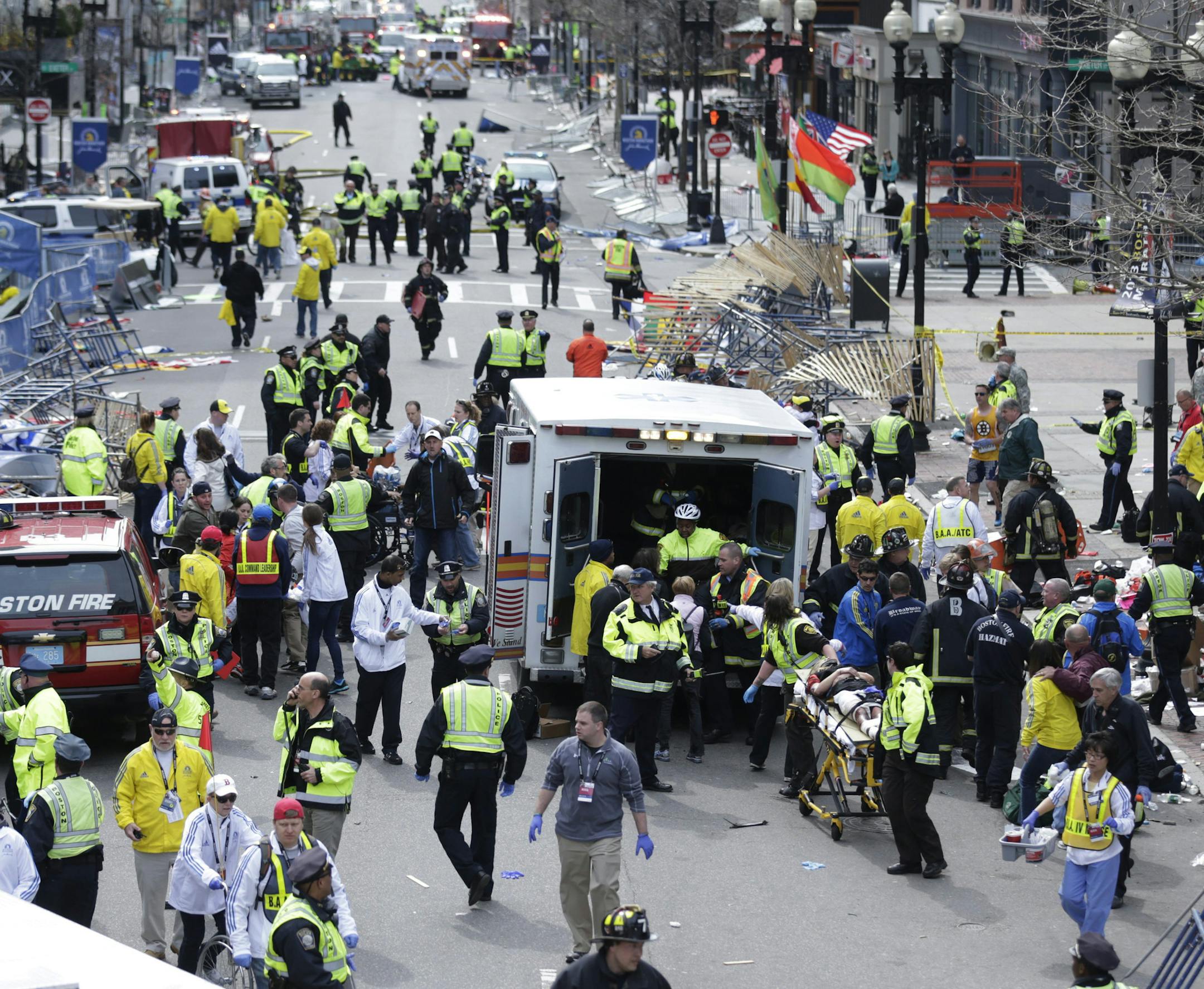 FILE This April 15, 2013 file photo shows medical workers aiding injured people at the finish line of the 2013 Boston Marathon in Boston following an explosion. If the Obama administration seeks the death penalty against Boston Marathon bombing suspect Dzhokhar Tsarnaev, it would face a long, difficult legal battle with uncertain prospects for success in a state that hasn√≠t seen an execution in nearly 70 years. Attorney General Eric Holder will have to decide several months before