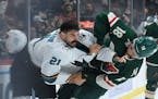 San Jose Sharks defenseman Jacob Middleton (21) and Minnesota Wild left wing Jordan Greenway (18) fight in the first period Tuesday, Nov. 16, 2021 at 
