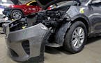A Kia that was damaged after being stolen sits in an auto repair shop in Milwaukee in 2021.