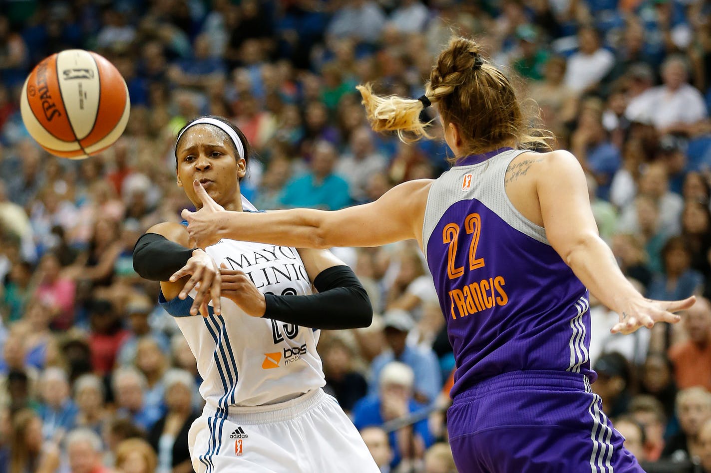 Minnesota Lynx forward Maya Moore (23) makes a pass against Phoenix Mercury center Cayla Francis (22) during the first half of a WNBA basketball game, Sunday, Aug. 30, 2015, in Minneapolis. (AP Photo/Stacy Bengs)