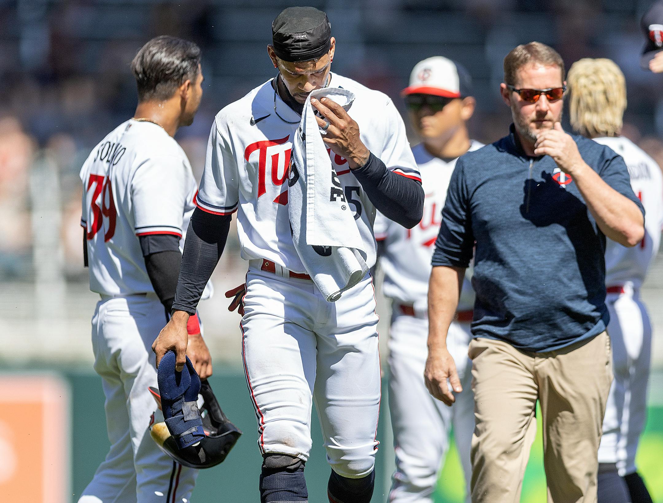 Minnesota Twins center fielder Byron Buxton (25) walks off the field after a collision with Chicago White Sox shortstop Lenyn Sosa (50) during the bottom of the seventh inning.