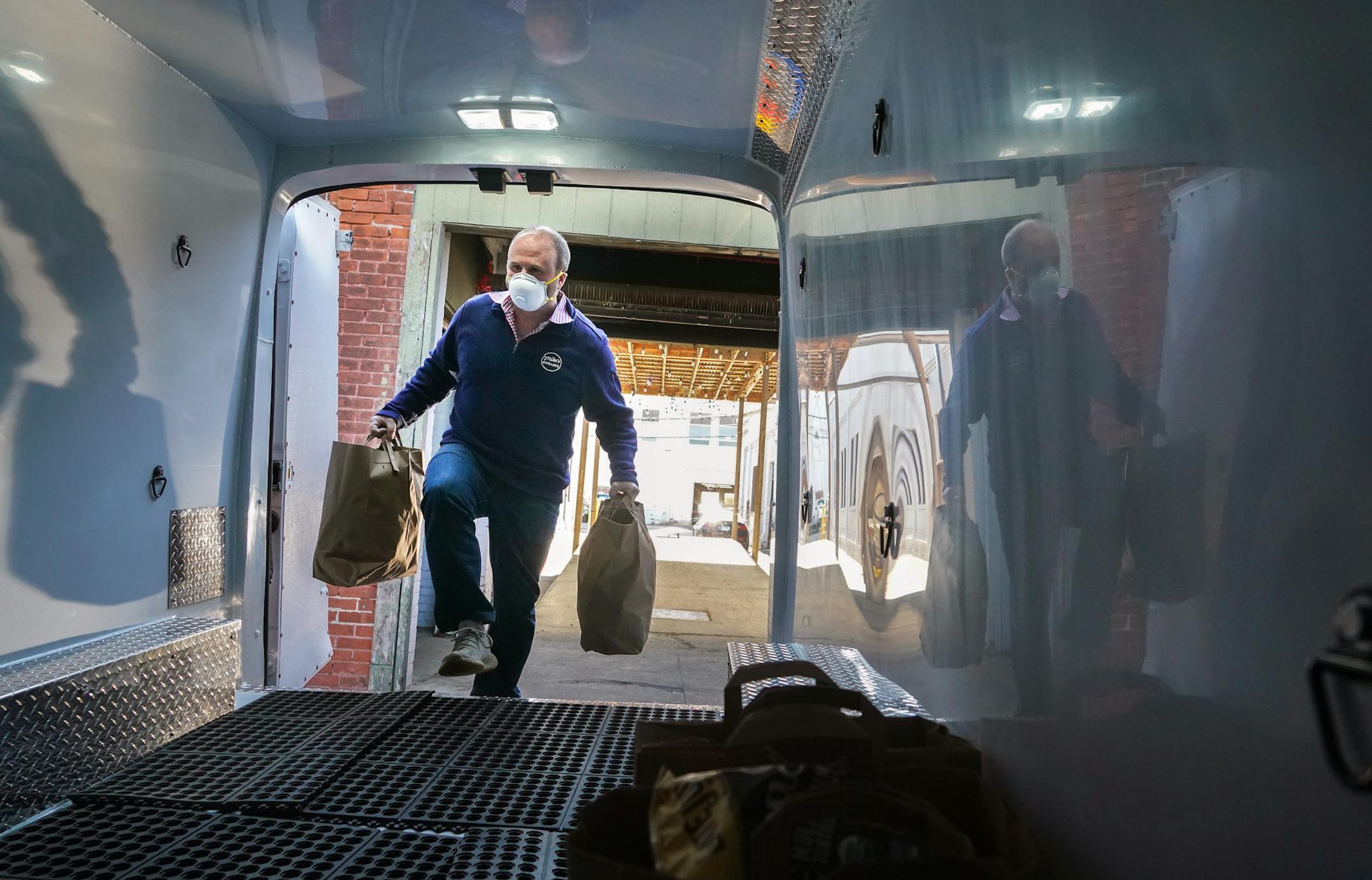 Mike Geller, owner of Mike's Organic Delivery, readied an order at his warehouse in Stamford, Conn., on May 12, 2020. For some companies, like Mike's Organic, embracing higher demand without changing their core strategy is the key to survival. (Chang W. Lee/The New York Times) ORG XMIT: XNYT35
