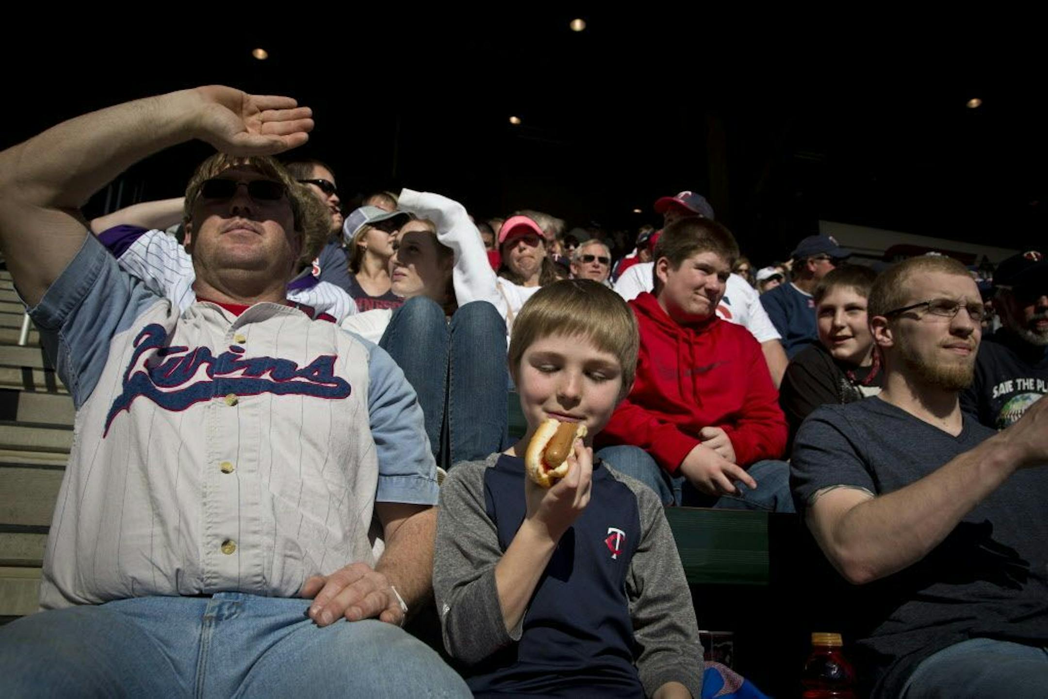 Graham Jacobson, 10, enjoyed a hot dog while watching a Twins game at Target Field in 2014. Last week fans hunting for hot dogs found long lines at concession stands.