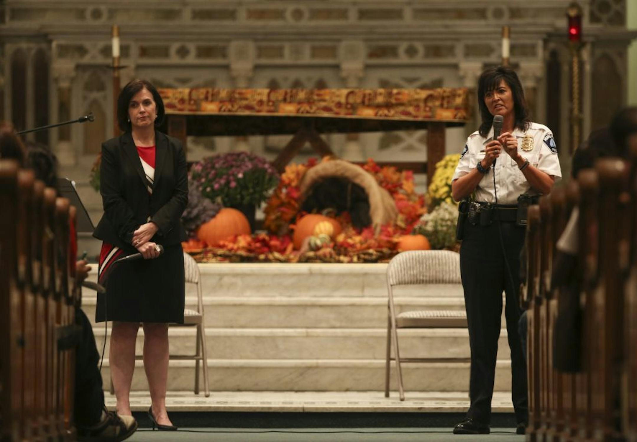Mayor Betsy Hodges listened as Police Chief Janee Harteau responded to a question from an audience member Monday night.