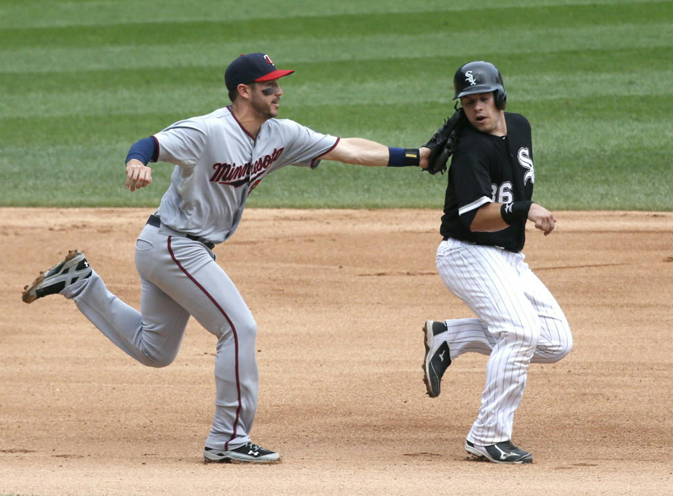 Minnesota third baseman Trevor Plouffe tags out Chicago White Sox's Josh Phegley in a rundown between second and third during the sixth inning Wednesday.