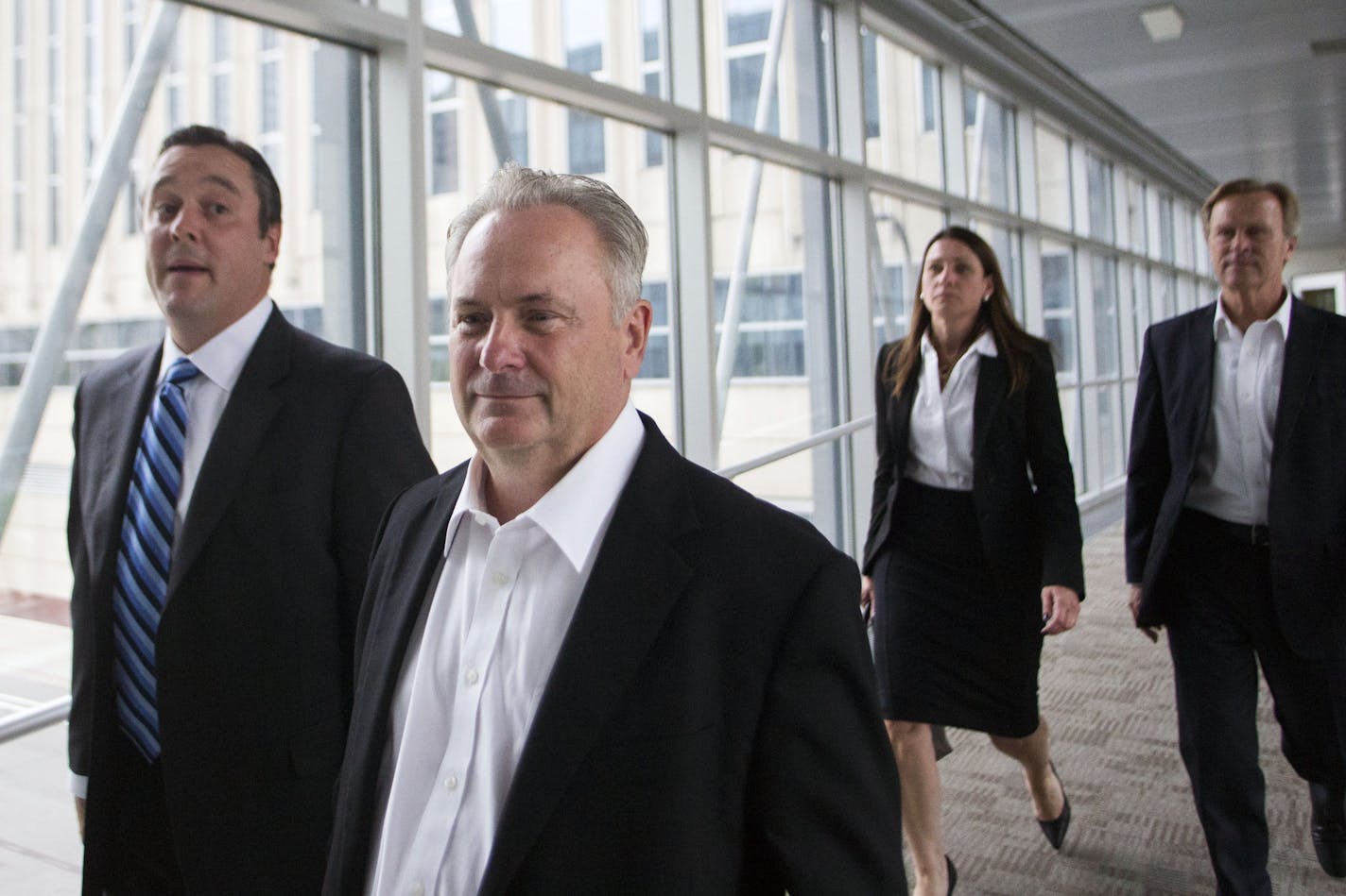 Former Starkey Hearing Technologies president Jerry Ruzicka and former Starkey human resources manager Larry Miller, right, leave the federal courthouse on Friday, Sept. 23, 2016. The criminal trial against the two, plus two business associates, began Wednesday morning. (MARK VANCLEAVE/Star Tribune file photo)