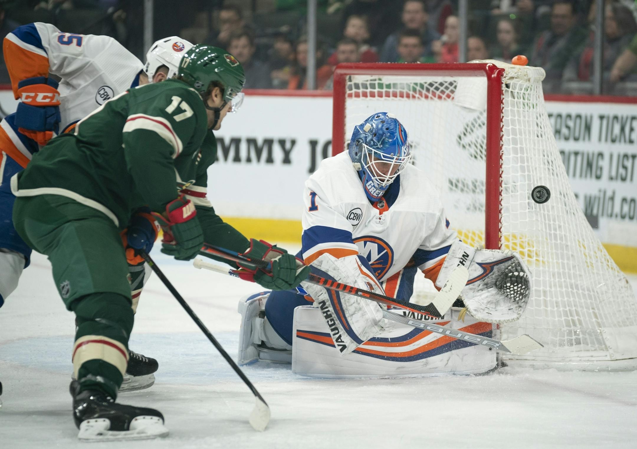 Minnesota Wild left wing Marcus Foligno's (17) backhander in the first period was a little wide of the goal and New York Islanders goaltender Thomas Greiss (1).