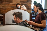 Ian Thompson got a trim Monday from Whitney Jones at Roosters Men’s Grooming Center in St. Louis Park. Roosters is one of Regis Corp.’s five main 