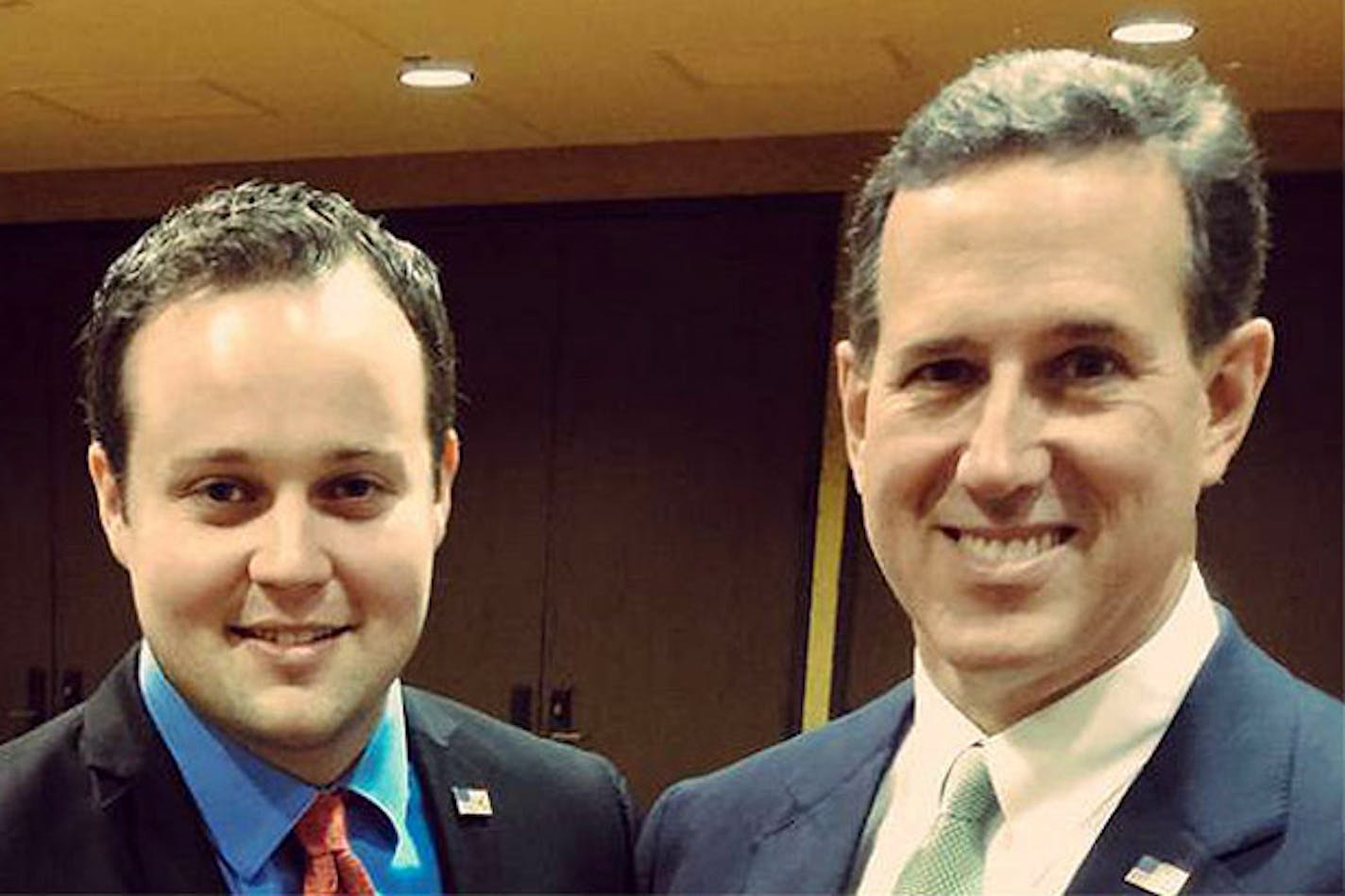 Josh Duggar, left, poses with GOP presidential candidate Rick Santorum.