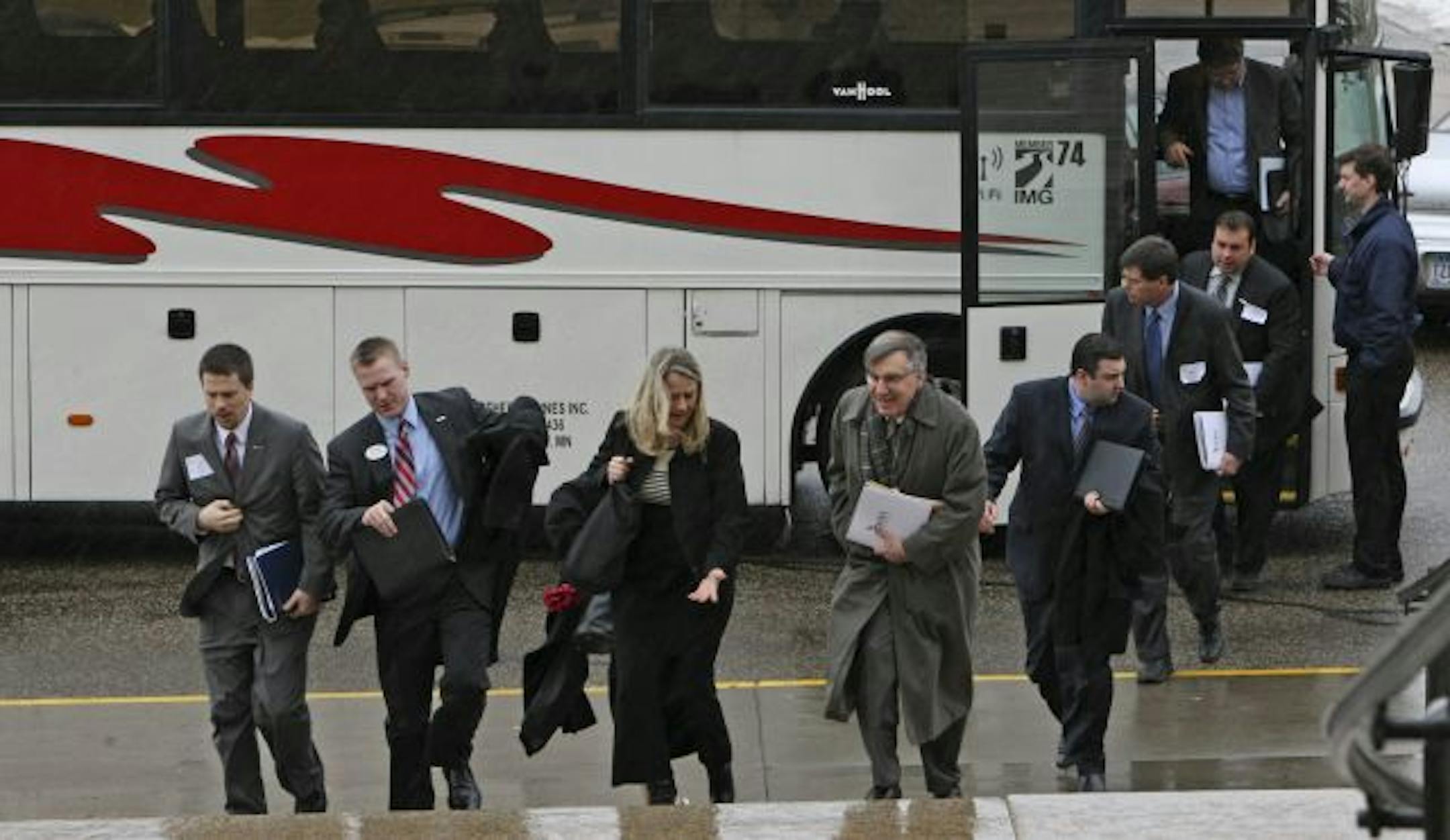 Members of the Minnesota Bankers Association scrambled through the rain as they arrived at the State Capitol Tuesday. Nearly 200 bankers from across the state gathered for lunch at a St. Paul hotel before boarding buses to meet legislators during the annual "Bank Day at the Capitol."