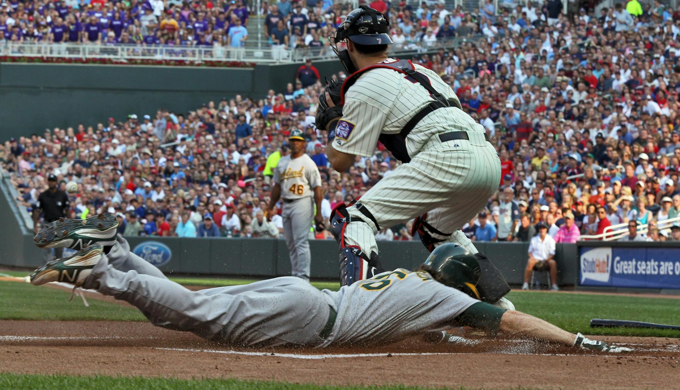 Minnesota Twins vs. Oakland Athletics. Oakland's Josh Reddick slid saflely into home beating the throw to Twins catcher Joe Mauer for the first run of the ballgame in the first inning. (MARLIN LEVISON/STARTRIBUNE(mlevison@startribune.com