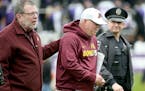 Minnesota's Jerry Kill made his way off the field alongside U of M President Eric Kaler after Minnesota lost to the Northwestern Wildcats 27-0 at Ryan