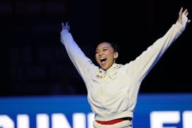 Suni Lee is introduced to the Target Center crowd before Day 2 of the United States Olympic trials for women's gymnastics Sunday in Minneapolis.