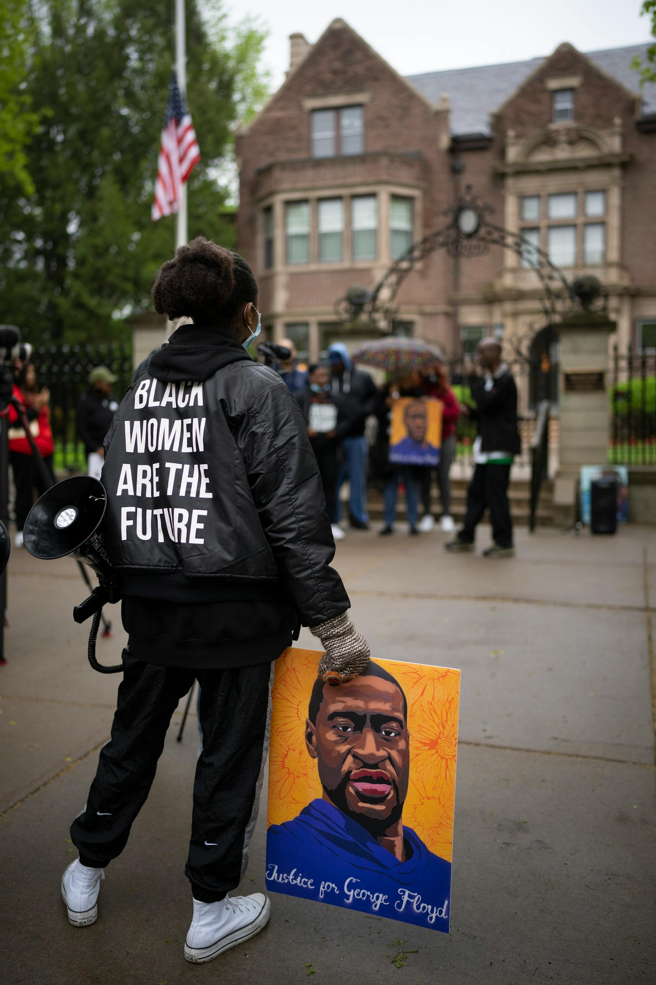 A small group that swelled to about 60 people gathered on the sidewalk in front of the Governor's Residence to honor the memory of George Floyd.