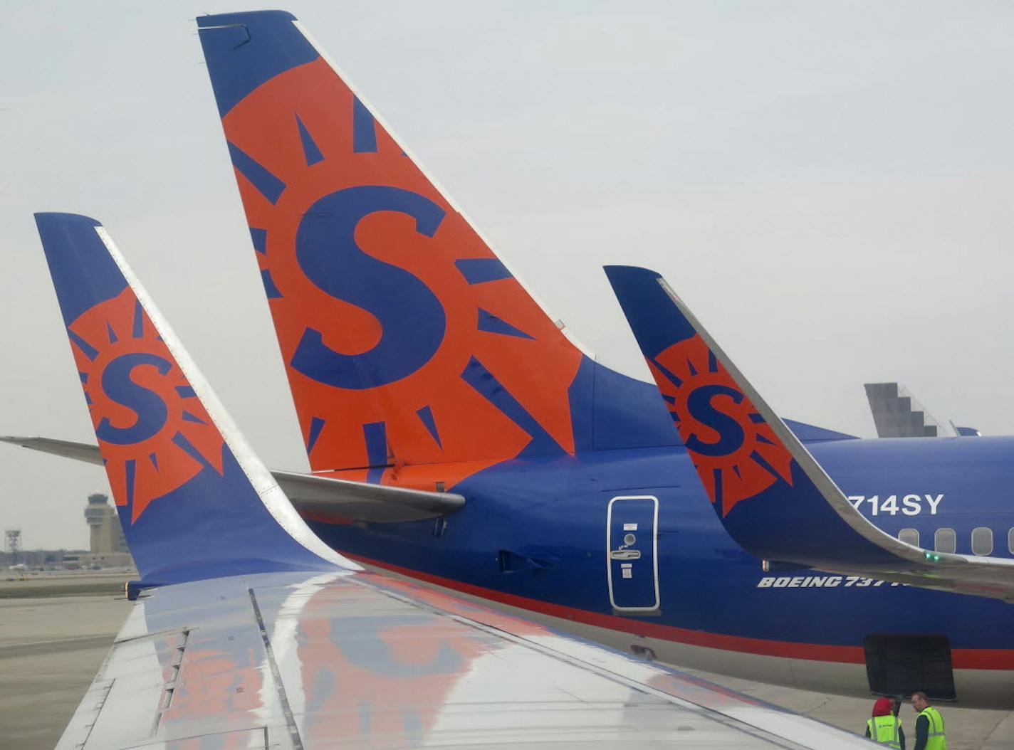 Sun Country airlines logo on 737 wing tips and tail at Humphrey terminal at the Minneapolis-St. Paul International Airport.