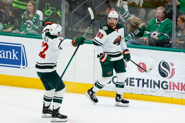 The Wild's Frederick Gaudreau is congratulated by Kevin Fiala after scoring the winning goal in overtime Thursday in Dallas.