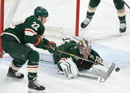 With the help of forward Kevin Fiala, Wild goalie Alex Stalock tried to cover the puck during Minnesota's 3-2 win over Colorado on Thursday night at X