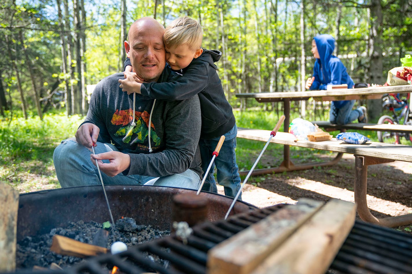 Elias Holmes, 5, hugged his father, Ian, while he roasted marshmallows at their campsite at Jay Cooke State Park.