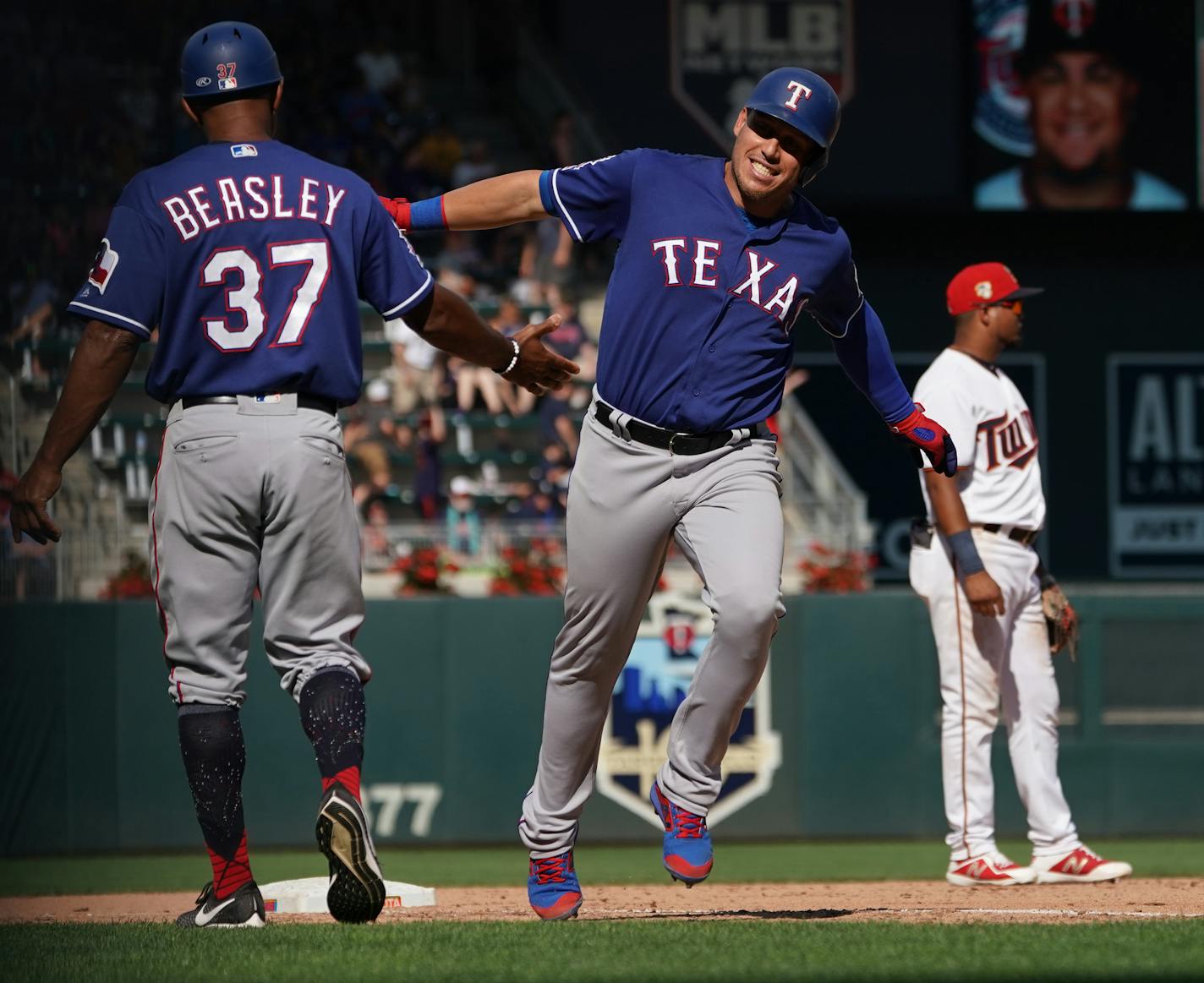 Rangers Joey Gallo(13) rounds 3rd base on a Rougned Odor(12) 3-run HR and slaps 3rd base coach Tony Beasley's hand.] At Target Field, the Twins take on the Texas Rangers on 7/7/19. RICHARD TSONG-TAATARII &#xa5; richard.tsong-taatarii@startribune.com