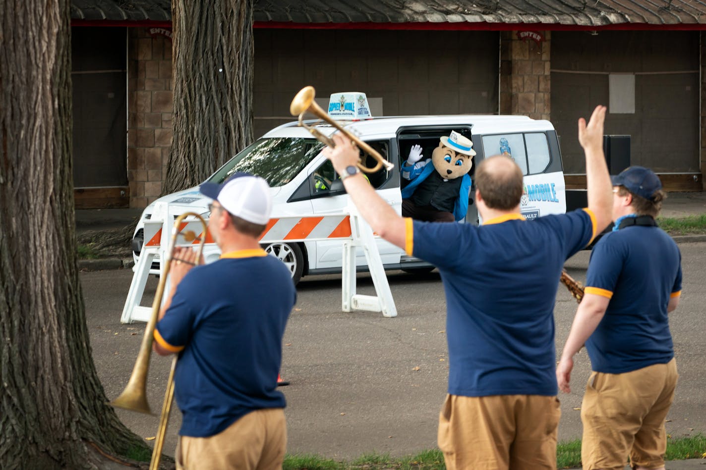 Members of the Jack Brass Band waved to the State Fair gopher mascott, cruising by in their Gopher Mobile during the Food Parade. the band played for folks participating in the Minnesota State Fair Food Parade in the Visitor's Plaza at the corner of Dan Patch and Underwood. ] GLEN STUBBE • glen.stubbe@startribune.com Friday, August 21, 2020 Local octet the Jack Brass Band talks about their fun but odd "drive-through" gig playing all 13 days of the Minnesota State Fair Food Parade (continuing thr