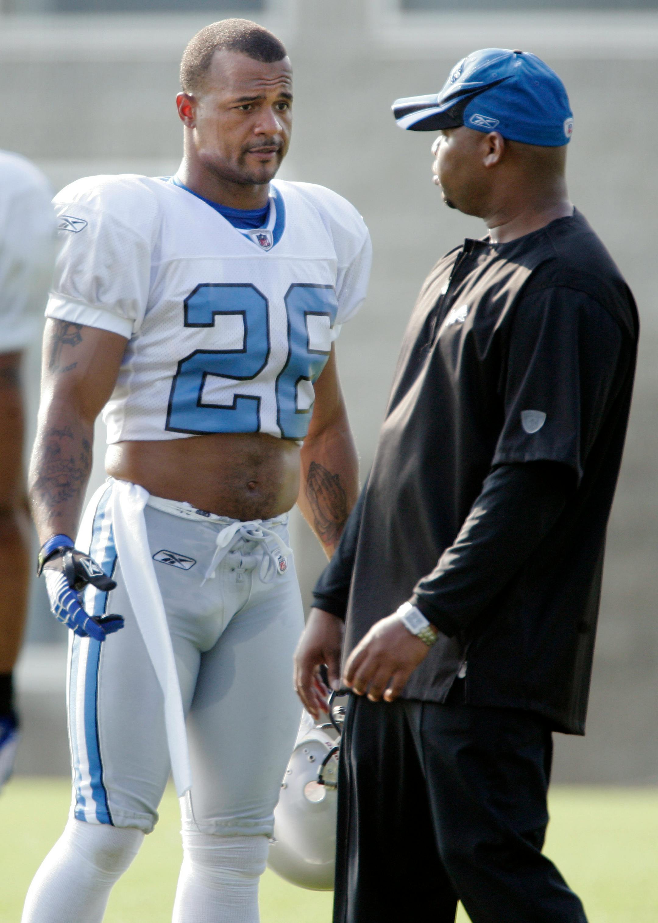 Detroit Lions' Dwight Smith, left, talks with assistant defensive backs coach Clayton Lopez during football training camp, Saturday, July 26, 2008, in Allen Park, Mich.