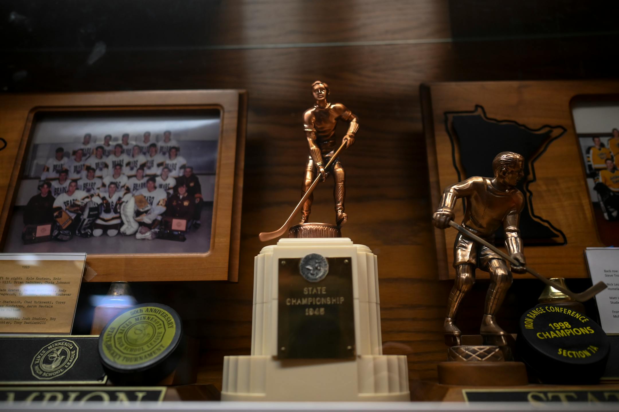 Eveleth's 1945 Minnesota State Championship trophy sits in a glass case at the Eveleth Hippodrome Monday, Feb. 21, 2022 in Eveleth, Minn. This was the first-ever Minnesota state high school hockey tournament championship.