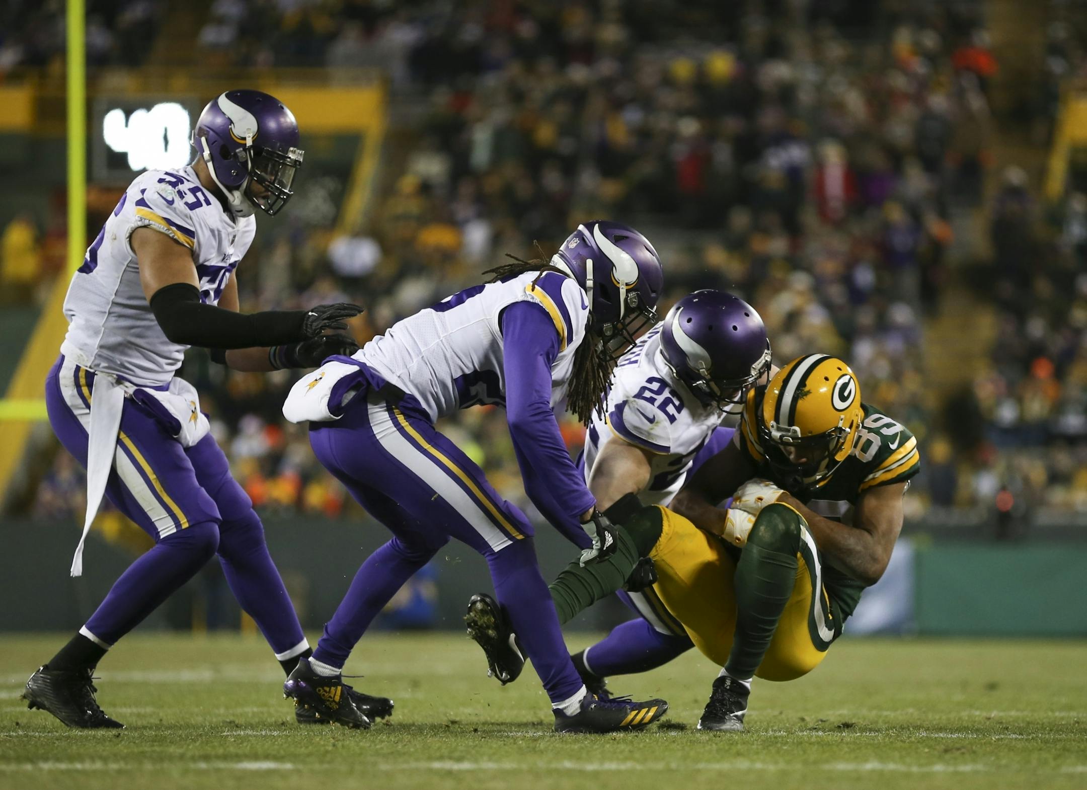 Vikings free safety Harrison Smith (22) tackled Green Bay Packers wide receiver Michael Clark (89) after he caught a fourth quarter pass for a seven yard gain. .