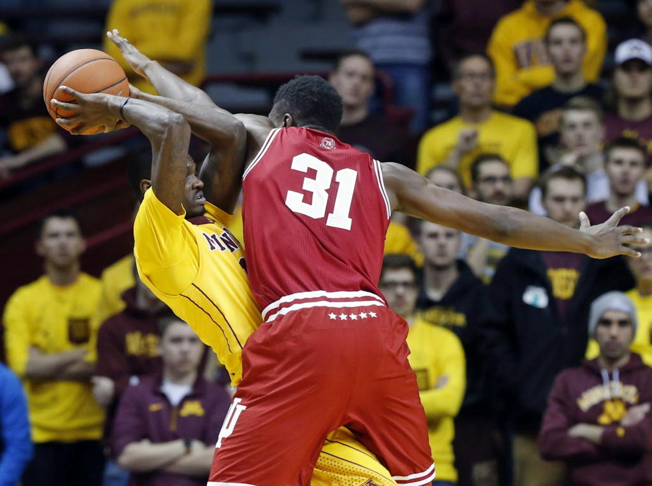 Indiana's Thomas Bryant, right, defends against Minnesota's Carlos Morris in the first half of an NCAA college basketball game, Saturday, Jan. 16, 2016, in Minneapolis.