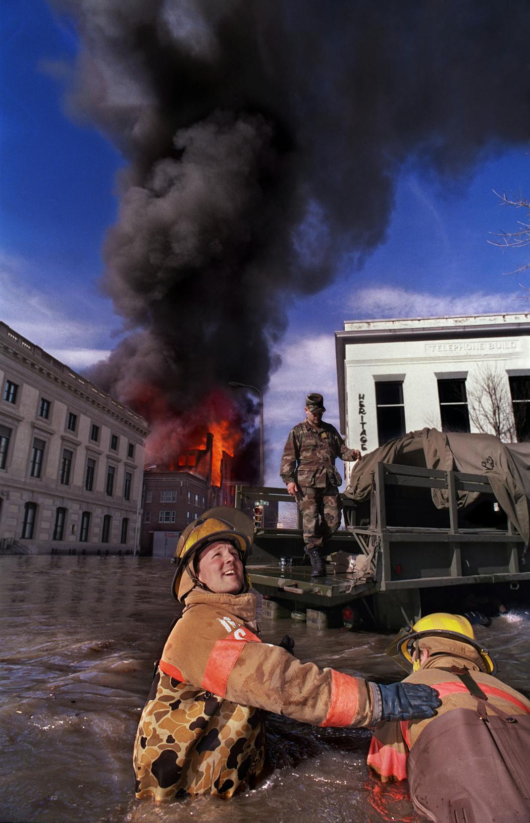 In 1997, Alkofer took this photo of Grand Forks firefighters Mike Sandie, left, and Randy Johnson battling a fire that destroyed a building in flooded downtown Grand Forks.