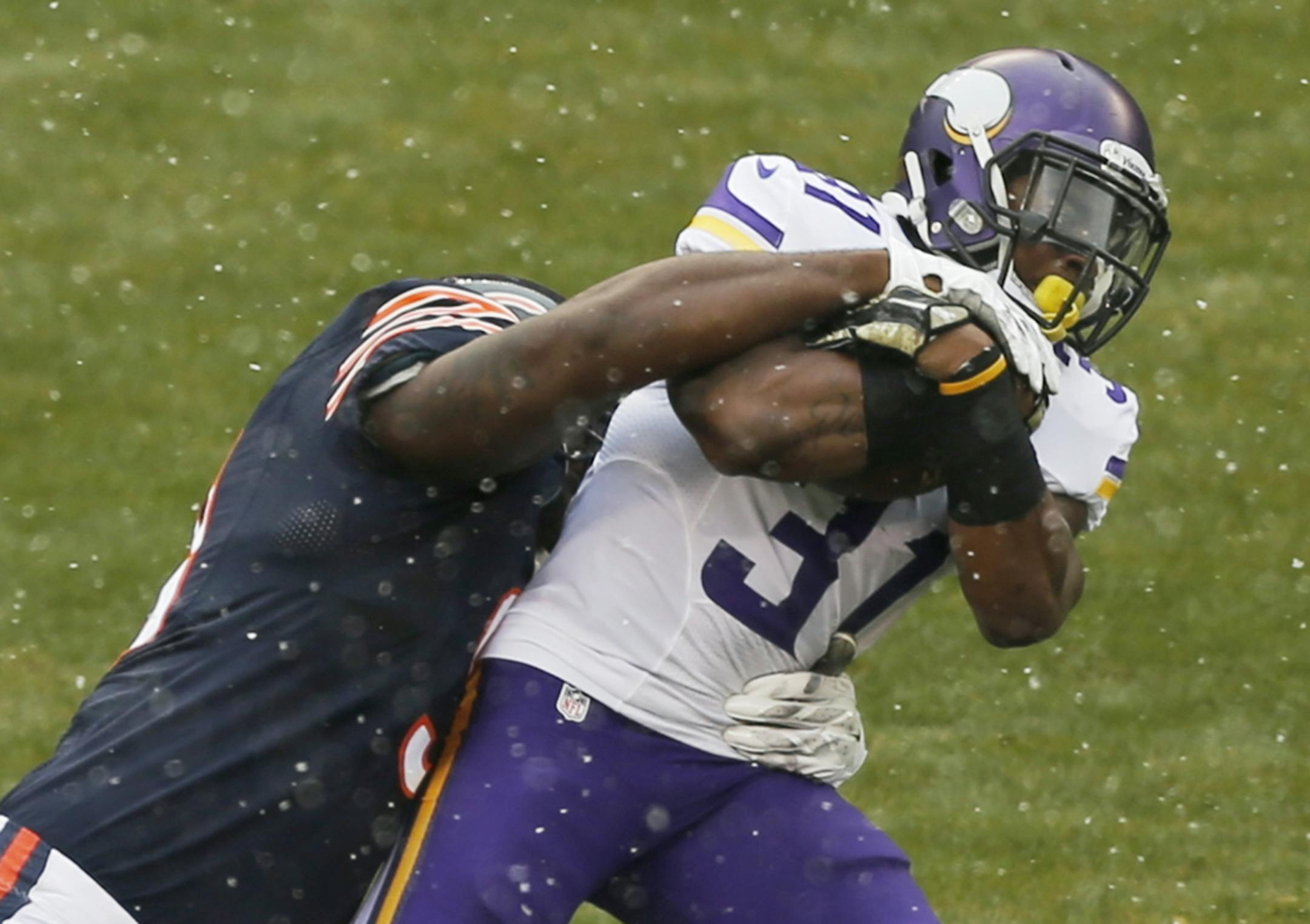 Chicago Bears defensive tackles Jeremiah Ratliff (90) tackles Minnesota Vikings running back Jerick McKinnon (31) during the first half of an NFL football game Sunday, Nov. 16, 2014 in Chicago.