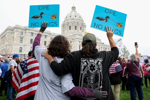 A couple embraces while protesting against the Trump administration during the No Kings protest outside the Minnesota State Capitol on Saturday, June 14, 2025, in St. Paul.