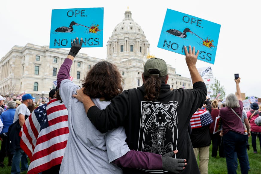 A couple embraces while protesting against the Trump administration during the No Kings protest outside the Minnesota State Capitol on Saturday, June 14, 2025, in St. Paul.