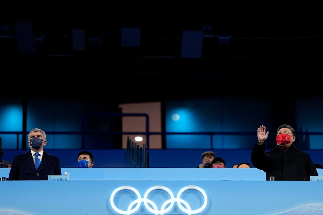 International Olympic Committee President Thomas Bach and Xi Jinping watch the closing ceremony.